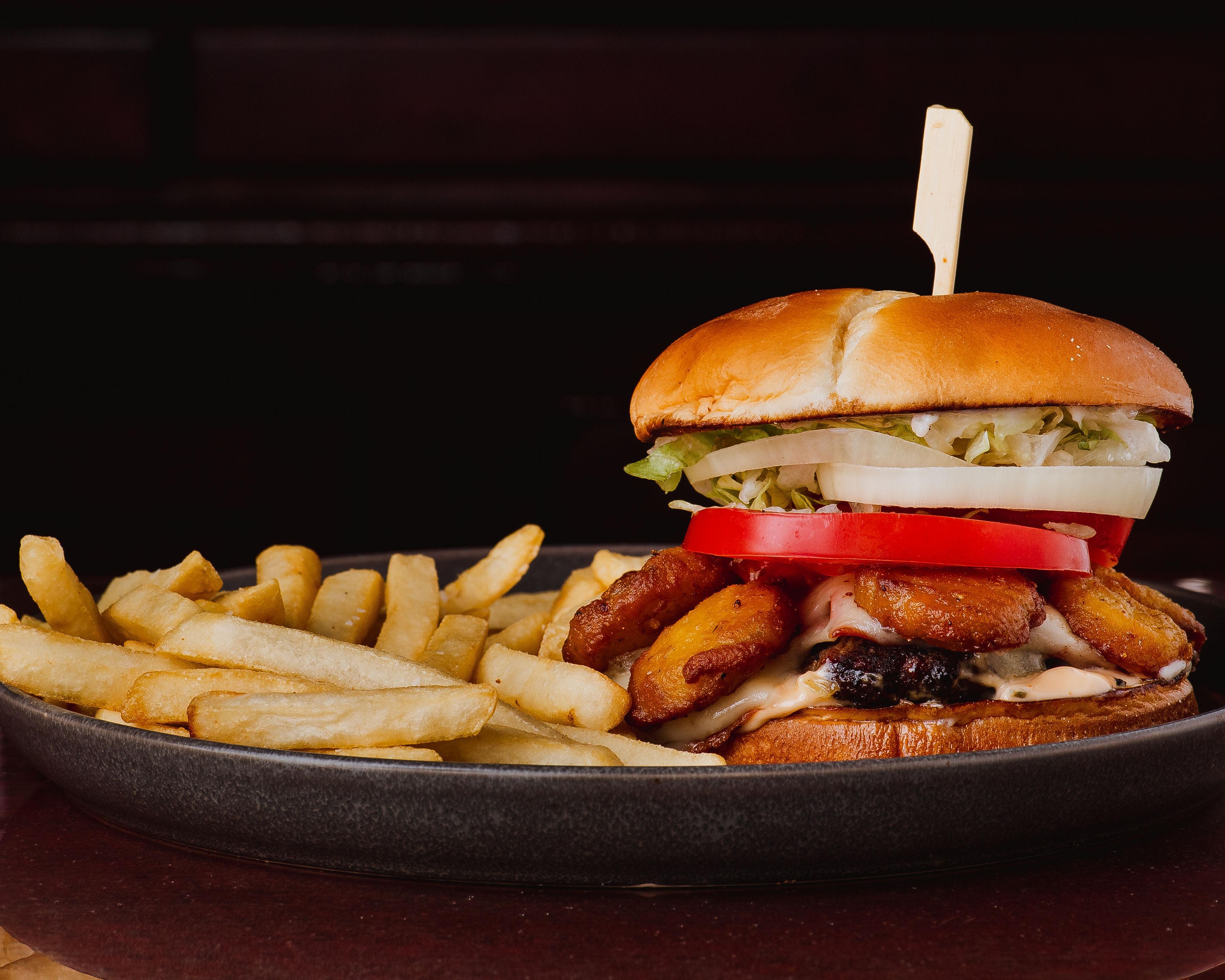 House burger with onion rings and fries